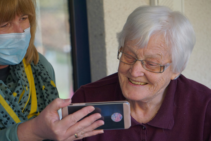 Aged care working helping resident