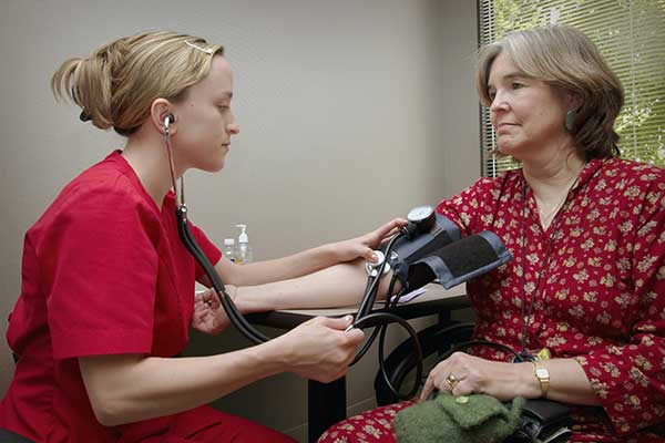 Young doctor helping patient