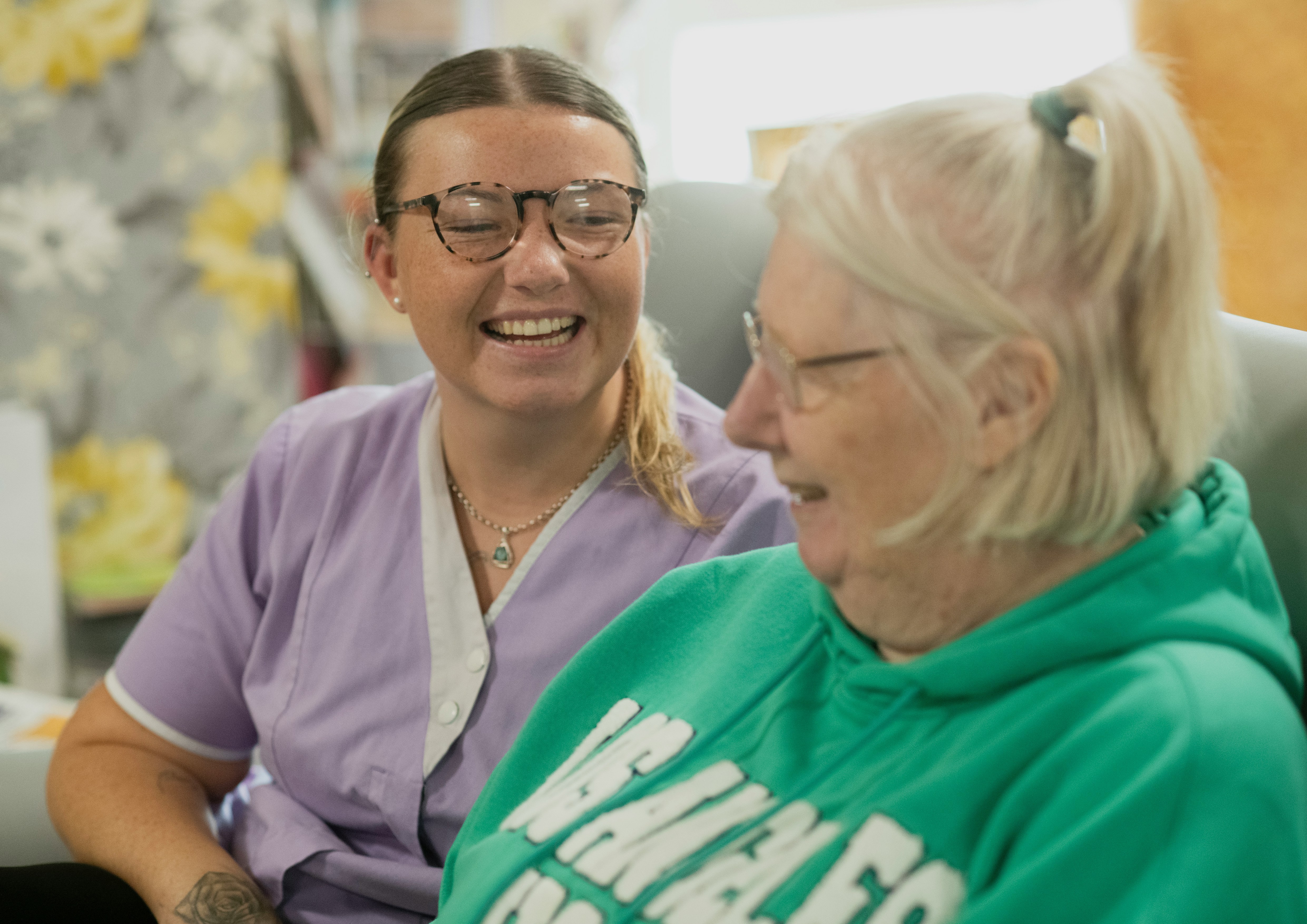 Healthworker supporting elderly person