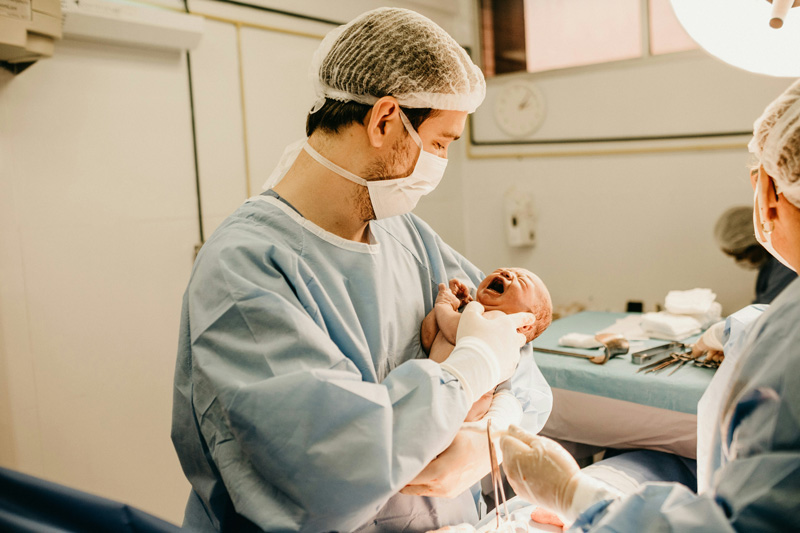 Dad holding newborn baby