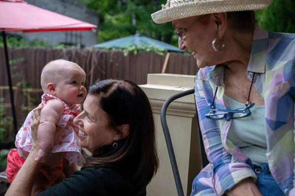 Mum holing baby and grandma smiling