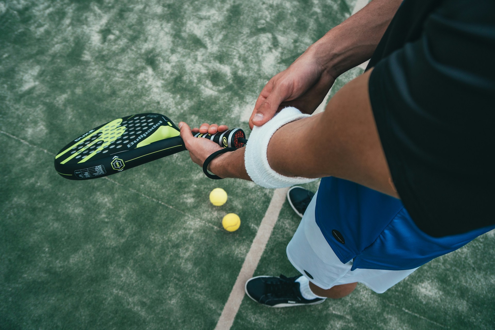 Person on padel court with racket